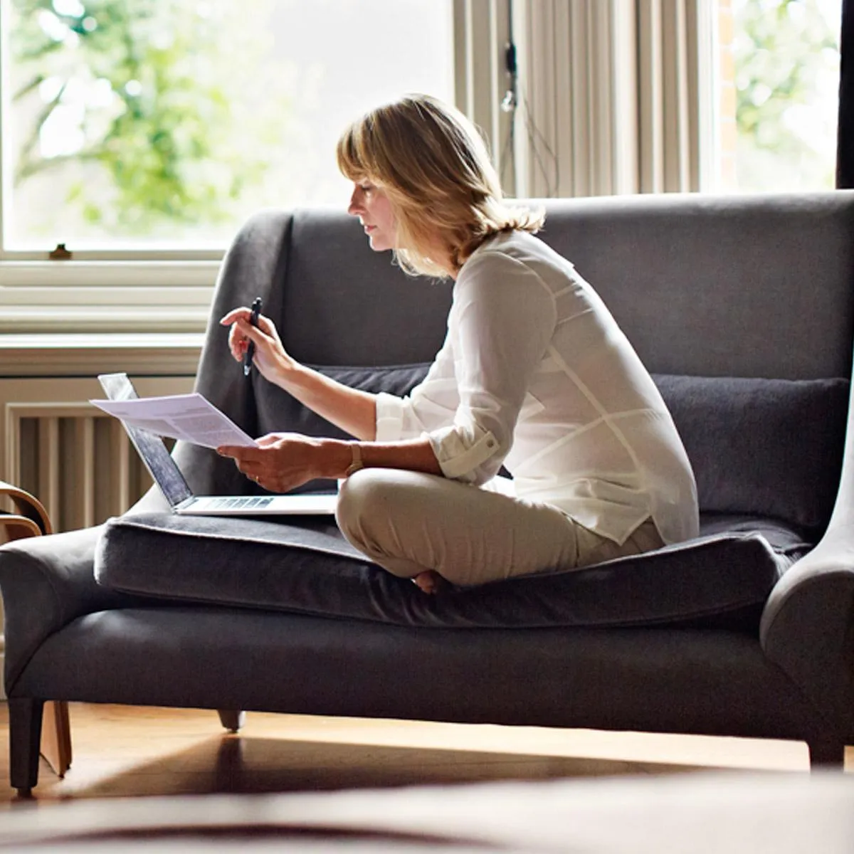 Couple exploring refinancing options for their USDA loan on a tablet in a cozy living room